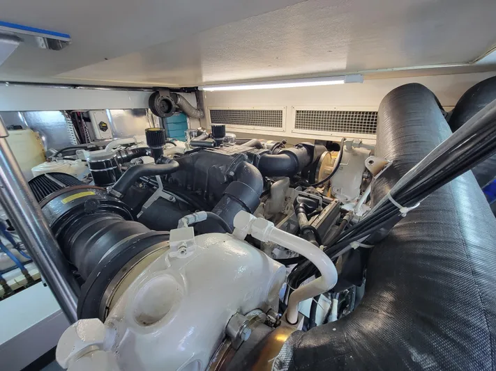  Yacht Photos Pics Engine room of 2005 Ocean Yachts 57 Super Sport, showcasing complex machinery and components.