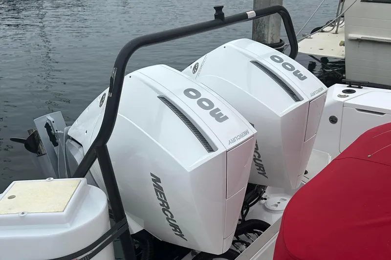 License To Chill Yacht Photos Pics Twin Mercury outboard engines on a 2023 Axopar Brabus boat, docked by the water.