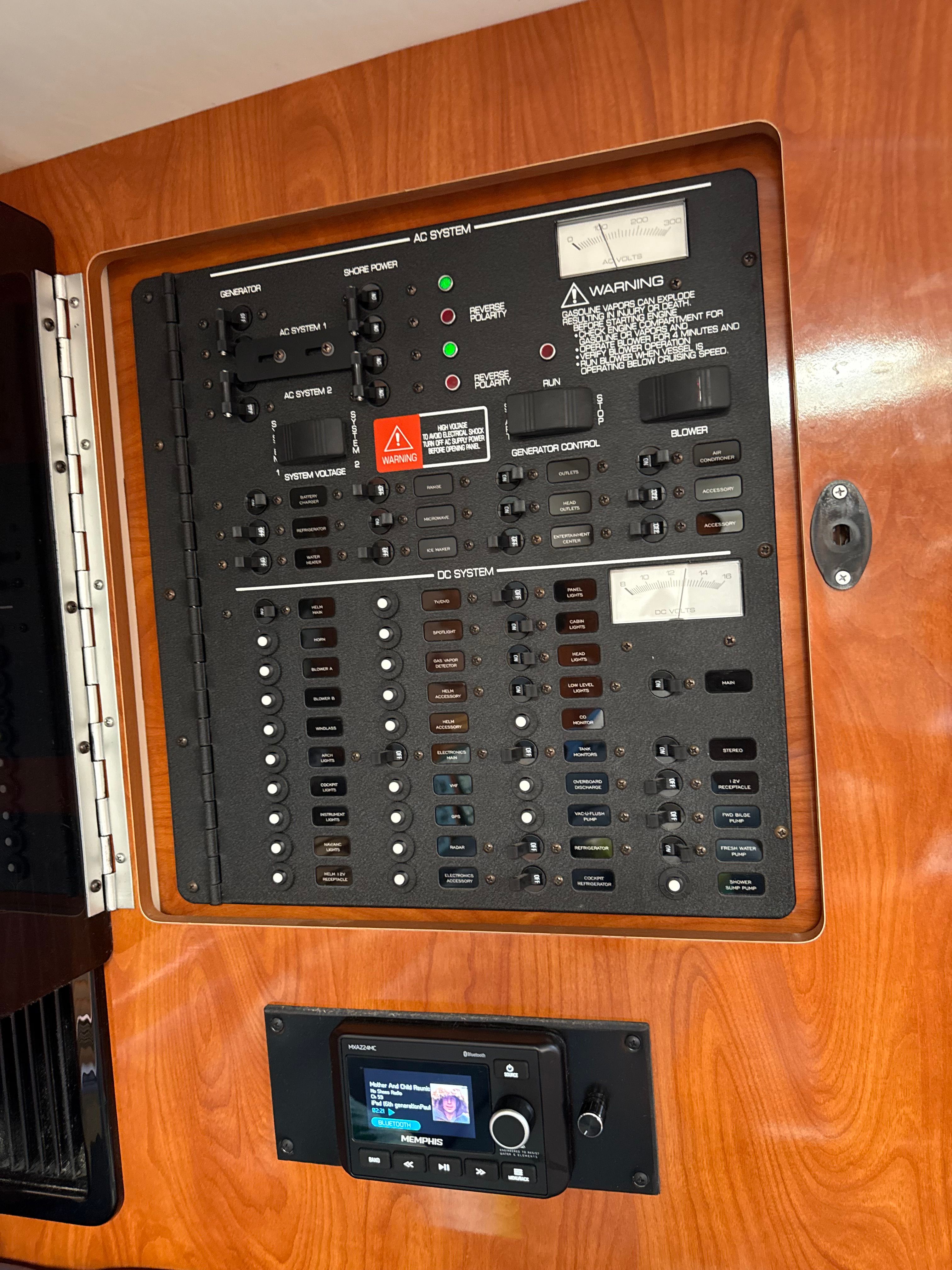 Electrical control panel on a 2004 Four 328 Vista boat, featuring AC and DC systems.