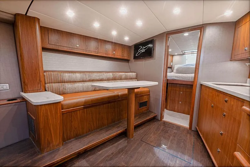 Jet Stream Yacht Photos Pics Luxurious interior of a 2018 Spencer Yachts Jet Boat with wood finishes and cozy seating.