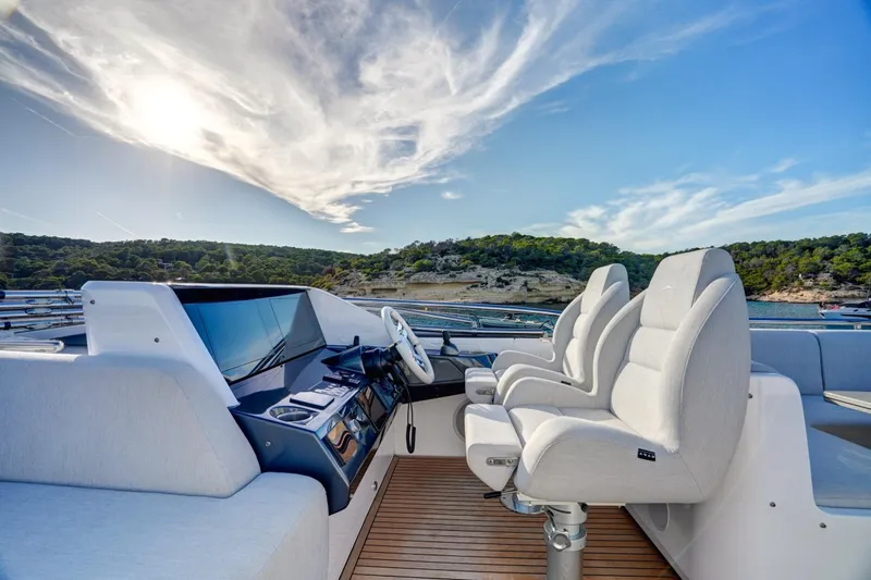 Apricity Yacht Photos Pics 2024 Azimut S8 yacht helm with luxurious seating and scenic coastal view.