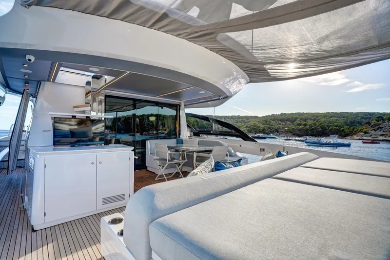 Apricity Yacht Photos Pics Luxurious 2024 Azimut S8 yacht deck with seating, dining area, and scenic ocean view.