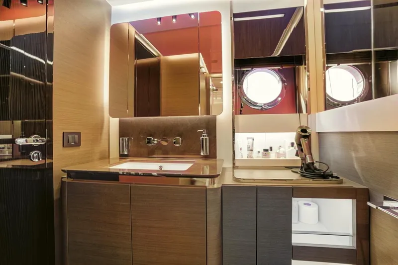 Apricity Yacht Photos Pics Luxurious bathroom interior of 2024 Azimut S8 yacht with modern fixtures and porthole window.