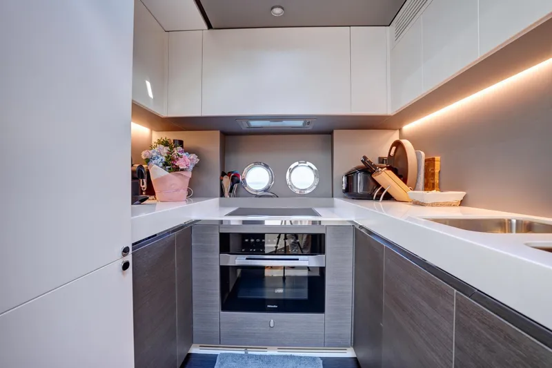 Apricity Yacht Photos Pics Luxurious 2024 Azimut S8 yacht kitchen with modern appliances and elegant design.