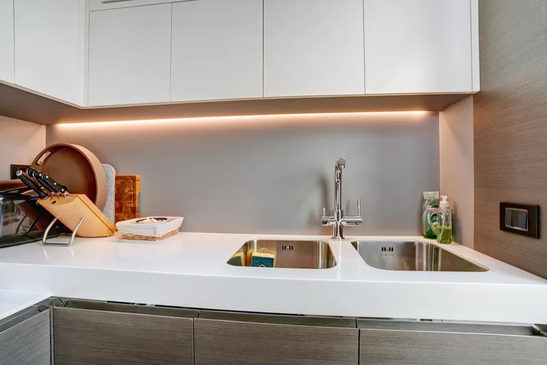 Apricity Yacht Photos Pics Modern kitchen sink area in 2024 Azimut S8 yacht, featuring dual sinks and sleek cabinetry.