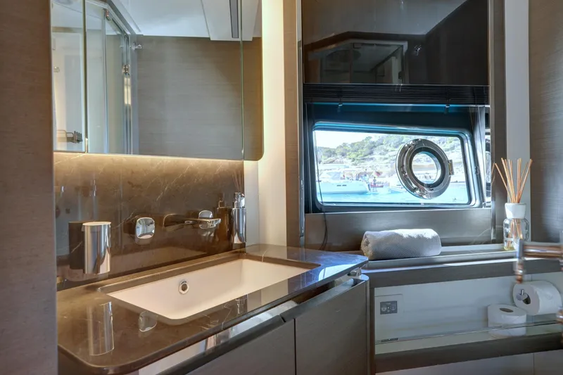 Apricity Yacht Photos Pics Luxurious bathroom in 2024 Azimut S8 yacht with elegant fixtures and scenic window view.