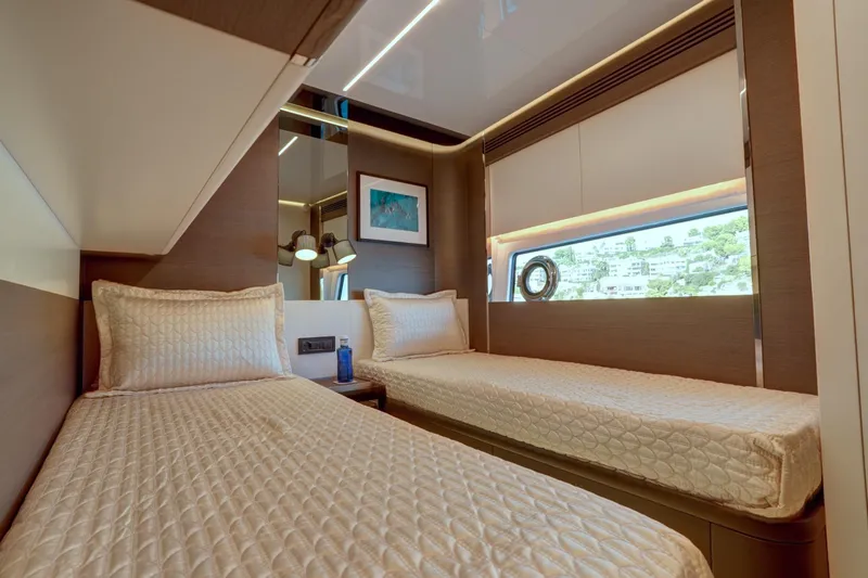 Apricity Yacht Photos Pics Luxurious twin cabin interior of 2024 Azimut S8 yacht, featuring elegant bedding and modern design.