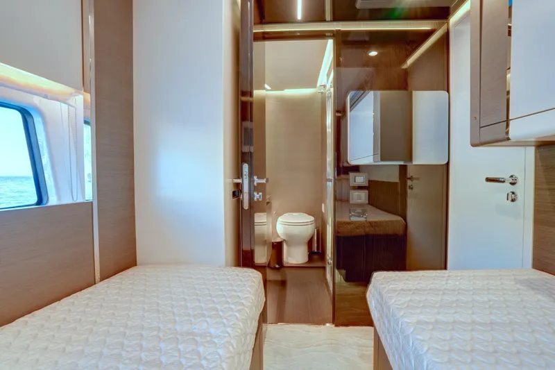 Apricity Yacht Photos Pics Luxurious interior of 2024 Azimut S8 yacht with twin beds and modern bathroom.