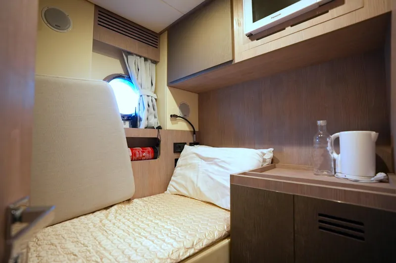 Apricity Yacht Photos Pics 2024 Azimut S8 yacht cabin with bed, porthole, and amenities.