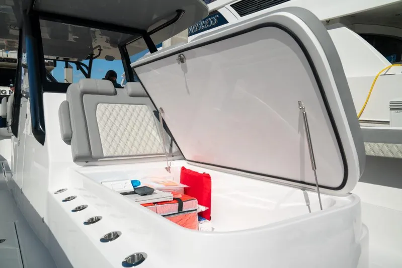  Yacht Photos Pics 2026 Front Runner 37 Catamaran with open storage compartment and cushioned seating.