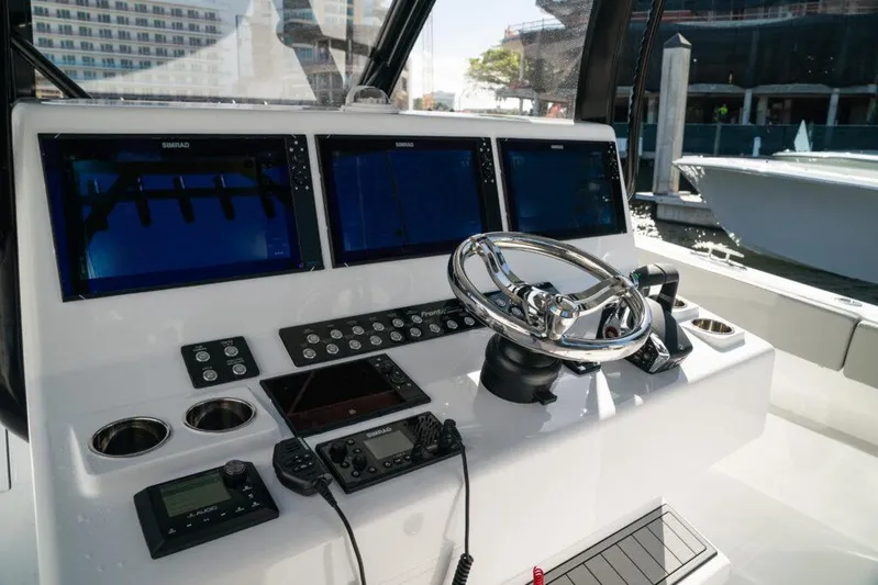  Yacht Photos Pics Control panel of 2026 Front Runner 37 Catamaran with advanced navigation systems and steering wheel.