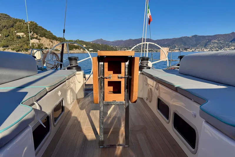  Yacht Photos Pics Italia Yachts 15.98 sailboat deck, 2021 model, with scenic coastal backdrop.