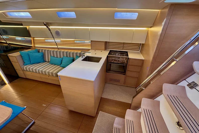  Yacht Photos Pics Modern interior of 2021 Italia Yachts 15.98 with sleek kitchen and cozy seating area.