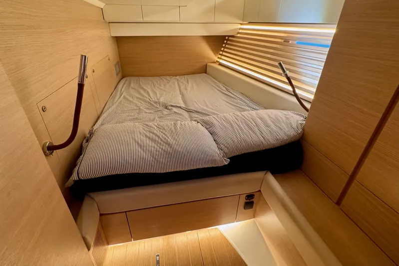  Yacht Photos Pics Luxurious cabin interior of 2021 Italia Yachts 15.98 with cozy bed and wooden finish.