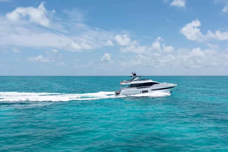 Euphoria Yacht Photos Pics Luxury Azimut 78 yacht cruising on turquoise ocean under clear blue sky, 2022 model.