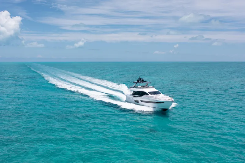Euphoria Yacht Photos Pics Azimut 78 yacht cruising on turquoise ocean, 2022 model, under clear blue sky.