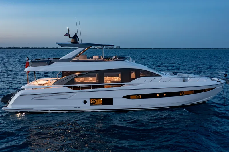 Euphoria Yacht Photos Pics Luxurious 2022 Azimut 78 yacht cruising on serene ocean waters at dusk.