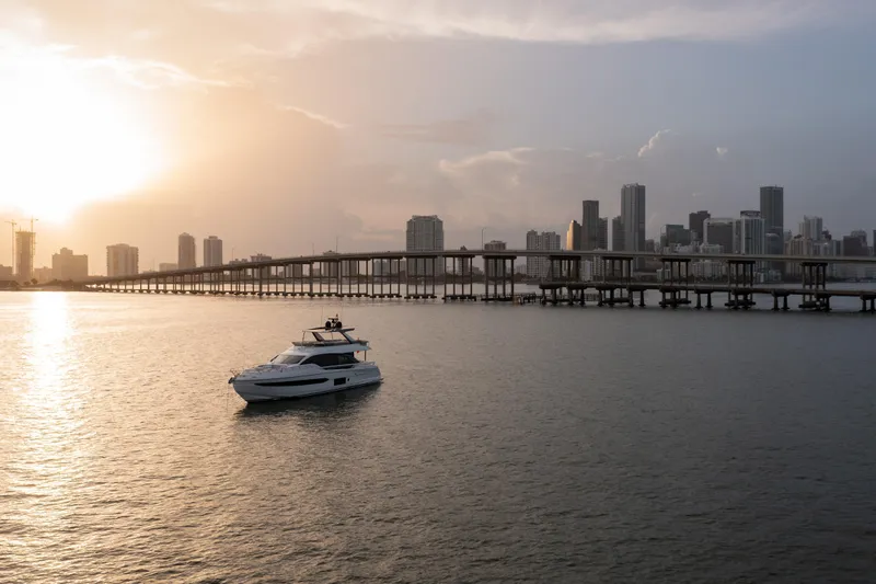 Euphoria Yacht Photos Pics Luxury Azimut 78 yacht cruising at sunset near city skyline, 2022 model.