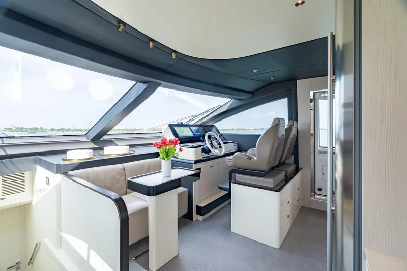 Euphoria Yacht Photos Pics Luxurious interior of 2022 Azimut 78 yacht with modern helm and seating area.