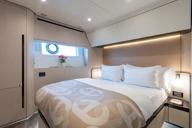 Euphoria Yacht Photos Pics Luxurious bedroom interior of 2022 Azimut 78 yacht with elegant bedding and modern lighting.