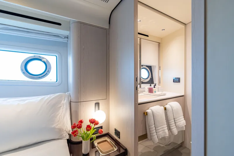 Euphoria Yacht Photos Pics Luxurious interior of 2022 Azimut 78 yacht featuring elegant bedroom and bathroom design.