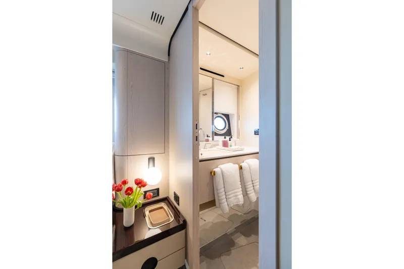 Euphoria Yacht Photos Pics Luxurious bathroom interior of 2022 Azimut 78 yacht with modern decor and fresh flowers.