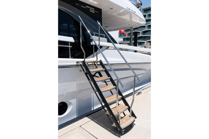Euphoria Yacht Photos Pics Staircase leading to a luxurious 2022 Azimut 78 yacht, docked at a marina.