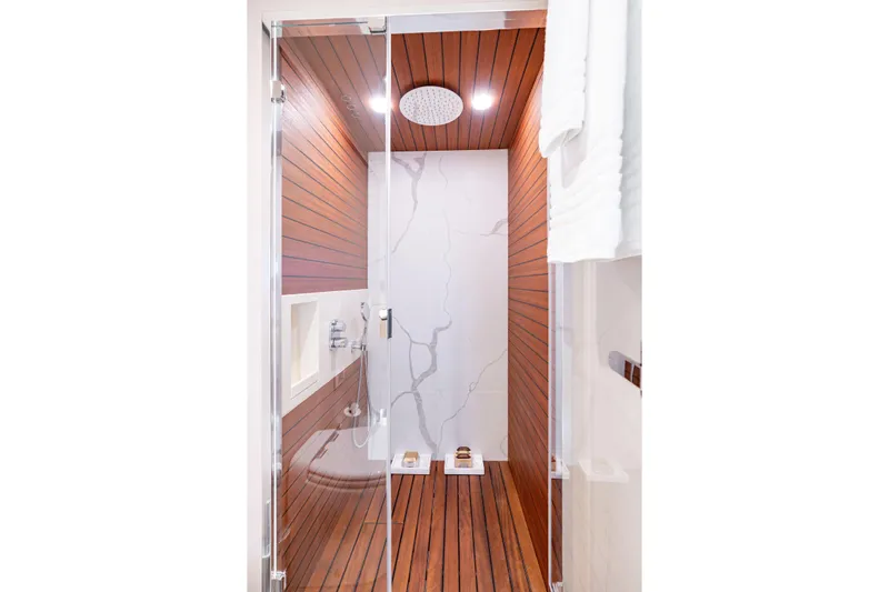 Euphoria Yacht Photos Pics Luxurious shower in 2022 Azimut 78 yacht with wood paneling and modern fixtures.