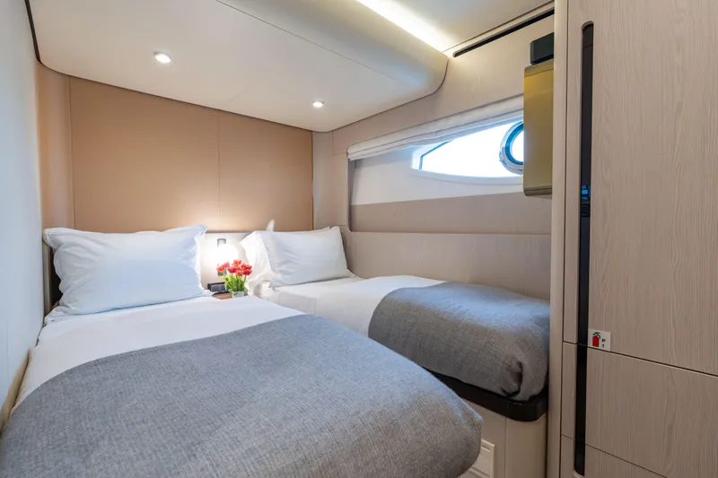 Euphoria Yacht Photos Pics Luxurious twin cabin interior on 2022 Azimut 78 yacht, featuring modern design and cozy bedding.