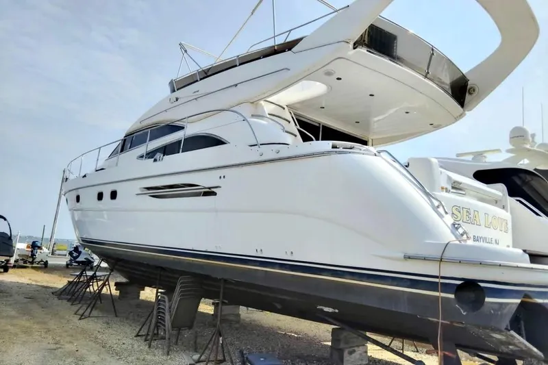  Yacht Photos Pics 2004 Viking Princess 61 Fly Bridge yacht on dry dock, side view.