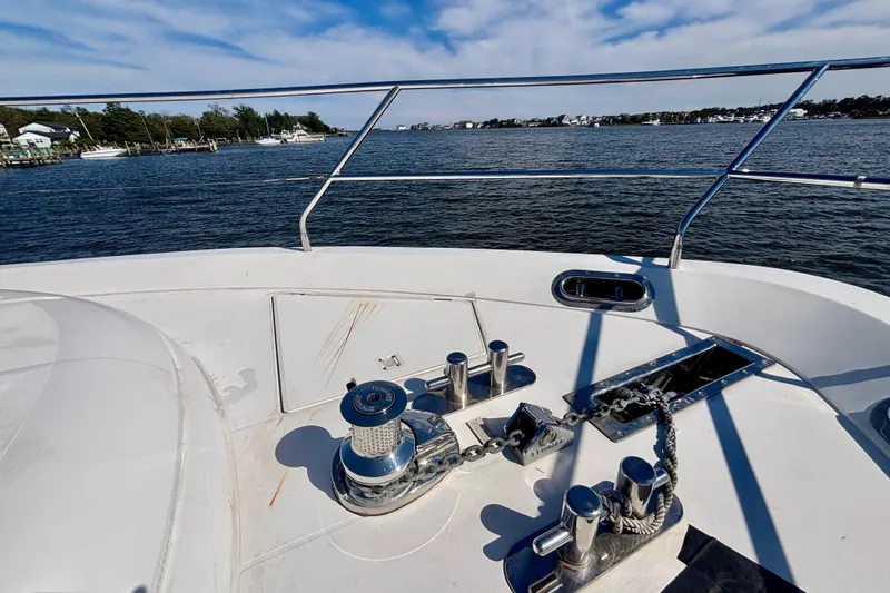  Yacht Photos Pics Bow view of 2004 Viking Princess 61 Fly Bridge yacht on calm waters.