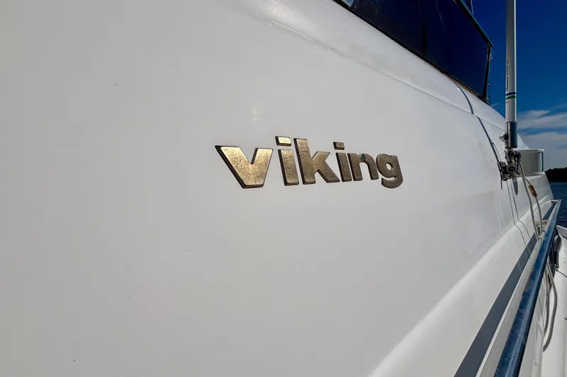  Yacht Photos Pics 2004 Viking Princess 61 Fly Bridge yacht with "Viking" logo on the side.