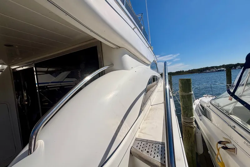  Yacht Photos Pics 2004 Viking Princess 61 Fly Bridge yacht docked by the water.