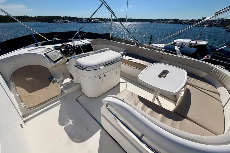  Yacht Photos Pics 2004 Viking Princess 61 Fly Bridge yacht with spacious seating and scenic water view.