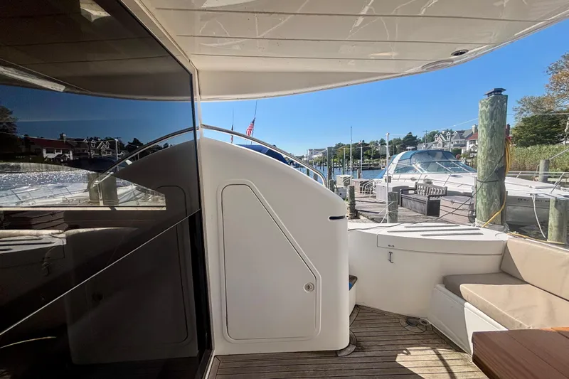  Yacht Photos Pics 2004 Viking Princess 61 Fly Bridge yacht docked at marina, featuring spacious deck area.