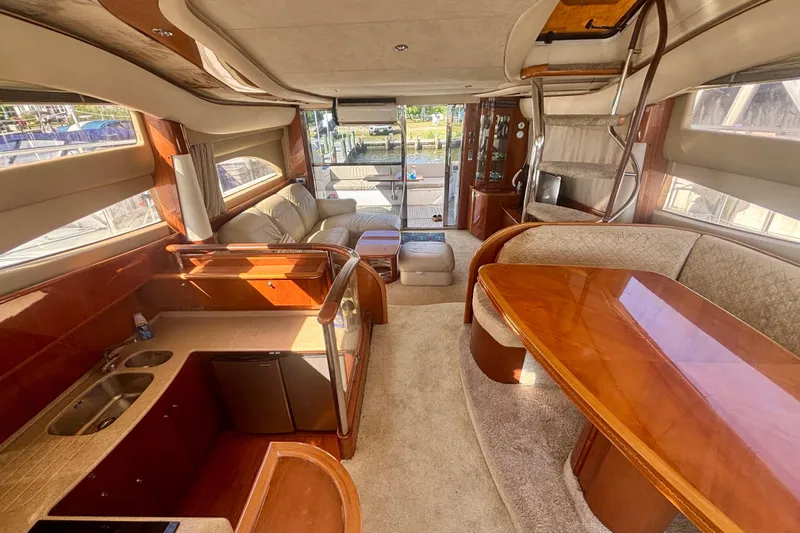  Yacht Photos Pics Luxurious interior of 2004 Viking Princess 61 Fly Bridge yacht with elegant wood finishes.