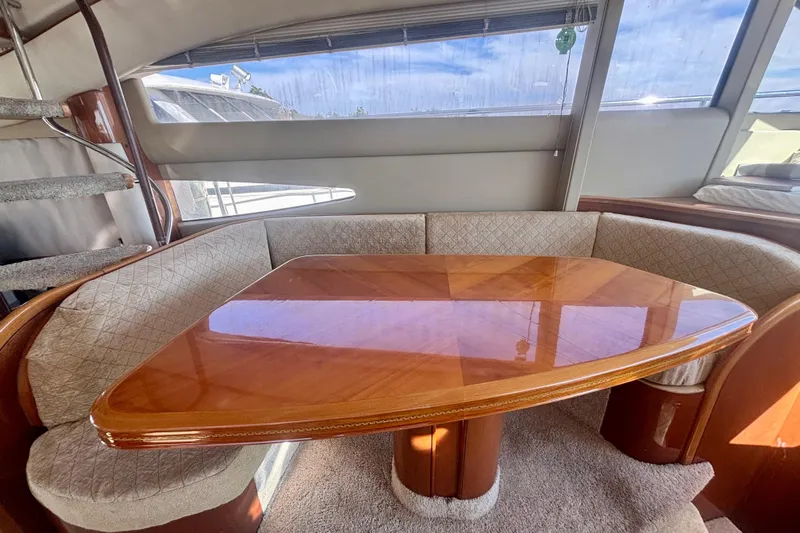  Yacht Photos Pics Luxurious interior of 2004 Viking Princess 61 Fly Bridge yacht with elegant wooden table.
