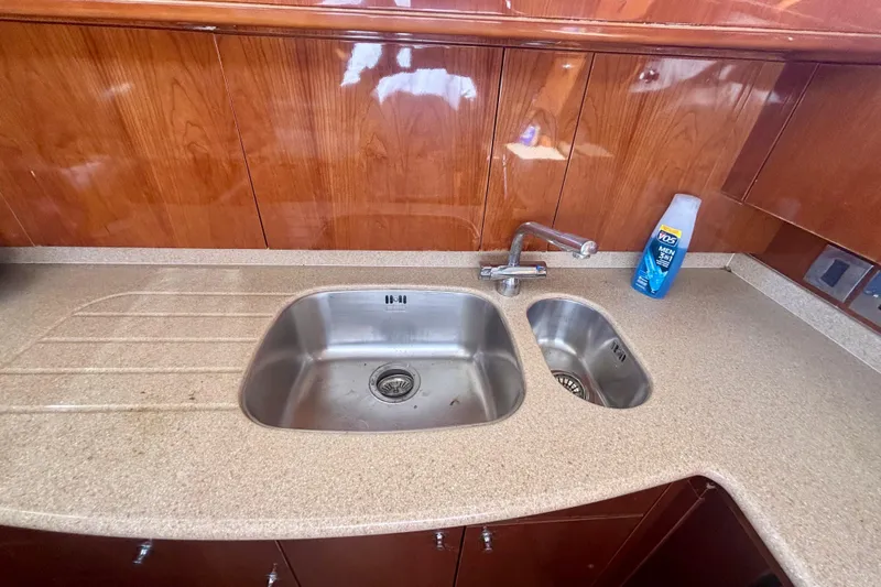  Yacht Photos Pics Kitchen sink area in 2004 Viking Princess 61 Fly Bridge yacht with wooden cabinetry.