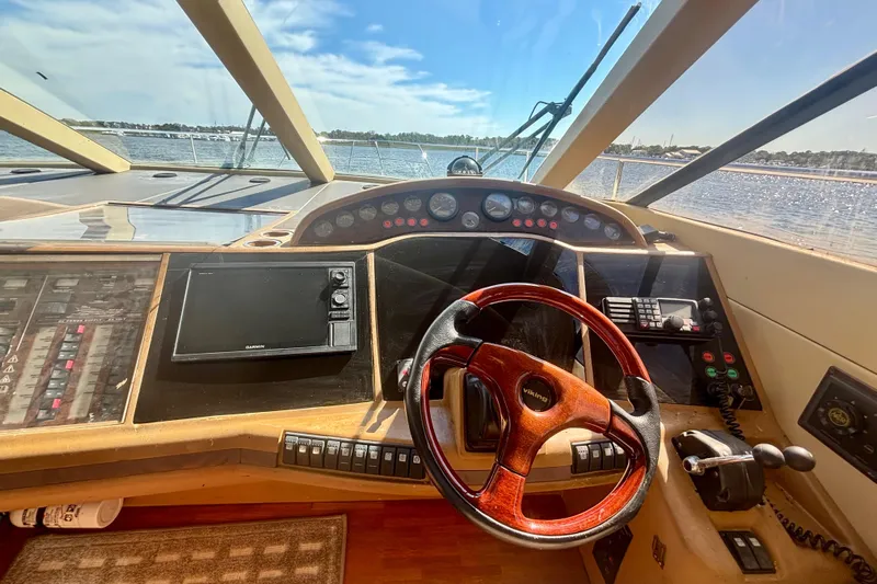  Yacht Photos Pics Cockpit view of 2004 Viking Princess 61 Fly Bridge yacht with steering wheel and controls.