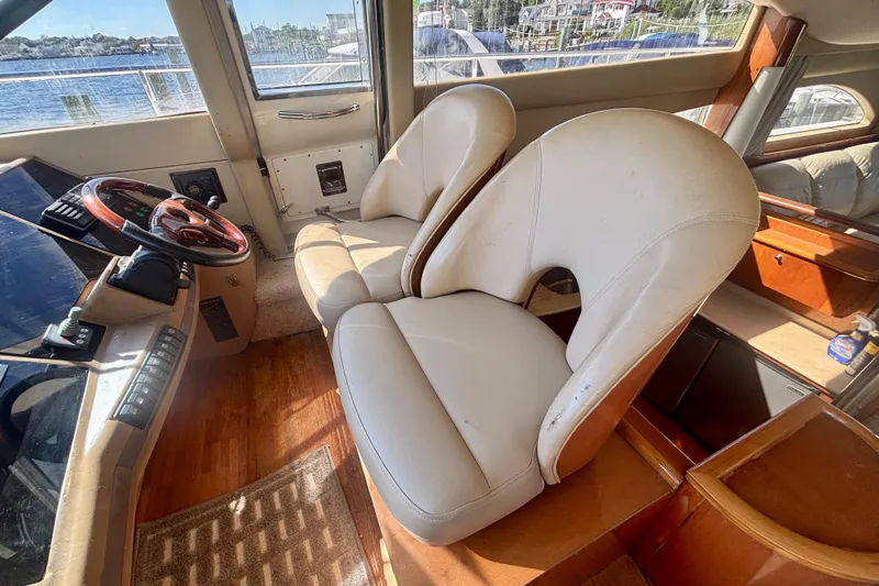  Yacht Photos Pics Interior of 2004 Viking Princess 61 Fly Bridge with leather seats and steering wheel.