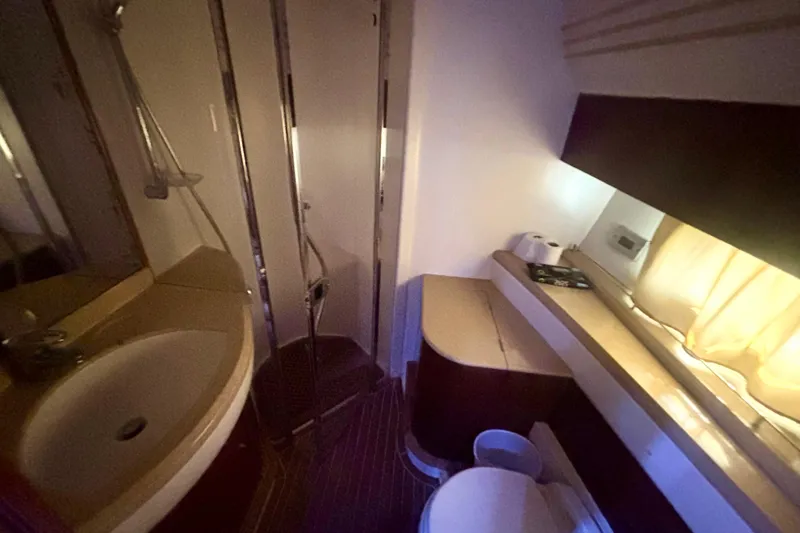  Yacht Photos Pics Bathroom interior of 2004 Viking Princess 61 Fly Bridge yacht, featuring sink and shower.