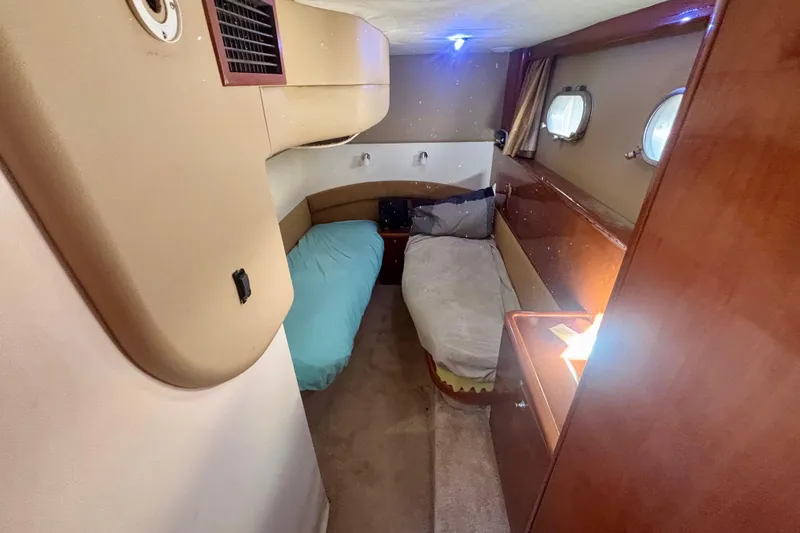  Yacht Photos Pics Cozy cabin interior of 2004 Viking Princess 61 Fly Bridge yacht with twin beds.