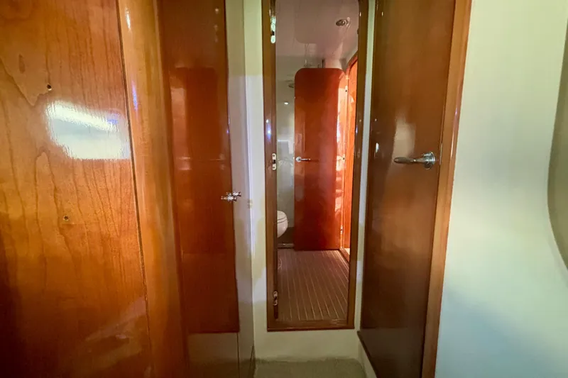  Yacht Photos Pics Interior hallway of 2004 Viking Princess 61 Fly Bridge yacht with wooden doors.