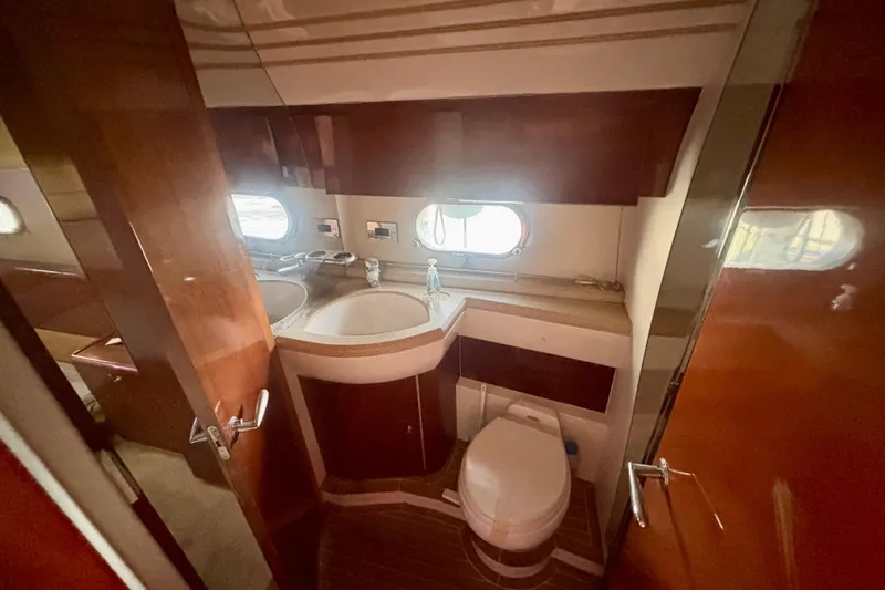  Yacht Photos Pics Luxurious bathroom in 2004 Viking Princess 61 Fly Bridge yacht, featuring elegant wood finishes.