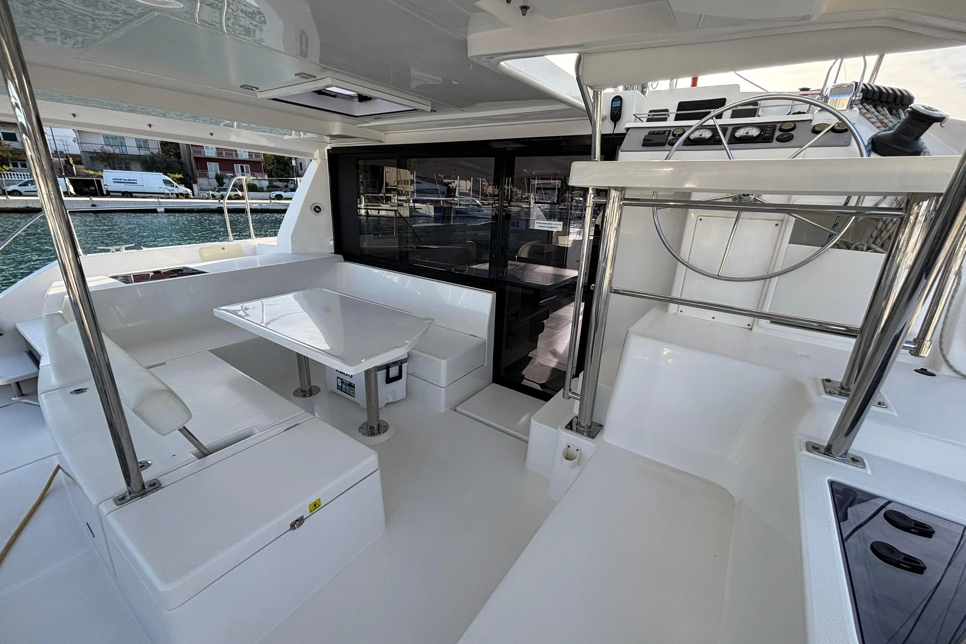 Spacious interior of a 2019 Leopard 40 catamaran with modern seating and helm station.