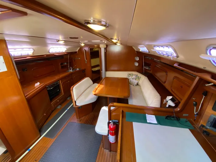 Cavallino Yacht Photos Pics Interior of 2000 Grand Soleil 46.3 yacht with wooden furnishings and cozy seating area.