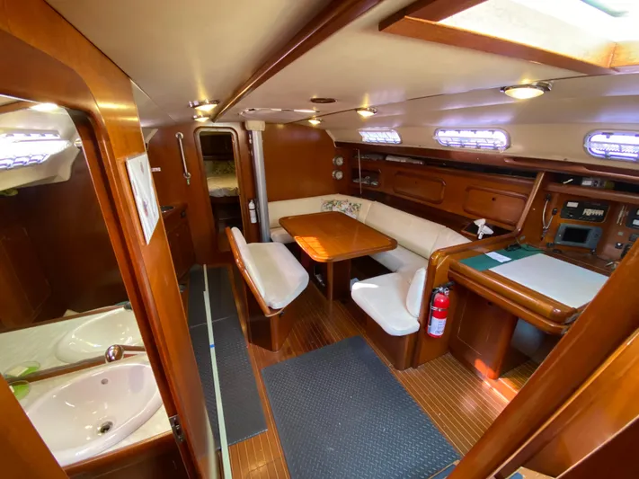 Cavallino Yacht Photos Pics Interior of 2000 Grand Soleil 46.3 yacht with wooden furnishings and cozy seating area.