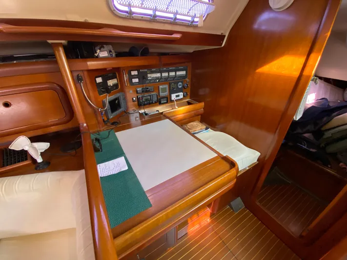 Cavallino Yacht Photos Pics Navigation station inside 2000 Grand Soleil 46.3 yacht with wooden interior and control panel.