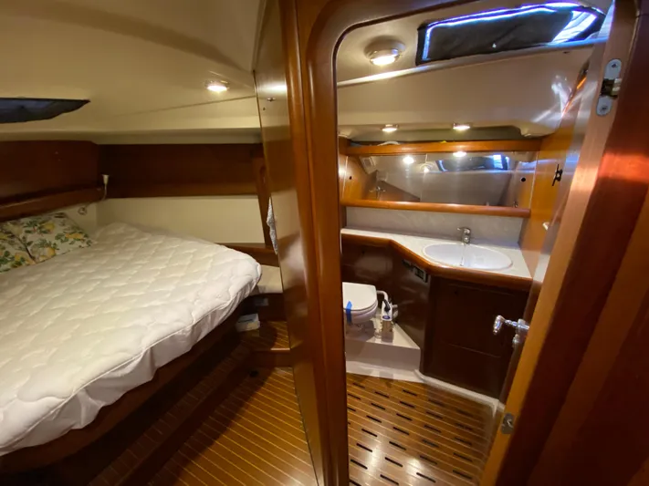 Cavallino Yacht Photos Pics Luxurious interior of 2000 Grand Soleil 46.3 yacht with cozy bedroom and modern bathroom.