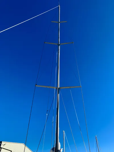Cavallino Yacht Photos Pics Tall mast of a 2000 Grand Soleil 46.3 sailboat against clear blue sky.